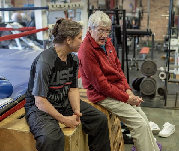 Bob and Andrea sitting by the ring at Ford's Gym