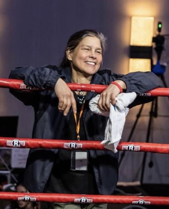 Andrea smiling from the red corner